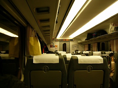 特急「しなの」列車内を座席から前を見て。窓は鏡になり、直接照明が生硬だ